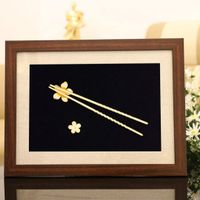 Bức tranh Đôi đũa mạ vàng với hàm ý “Con luôn biết ơn tới những bữa cơm đầm ấm, yên vui mà mẹ đã dành hết tình yêu thương vào đó” là món quà mẹ sẽ cực kỳ yêu thích. Hình ảnh cả gia đình quây quần bên mâm cơm gợi lên khung cảnh sum vậy đầm ấm.