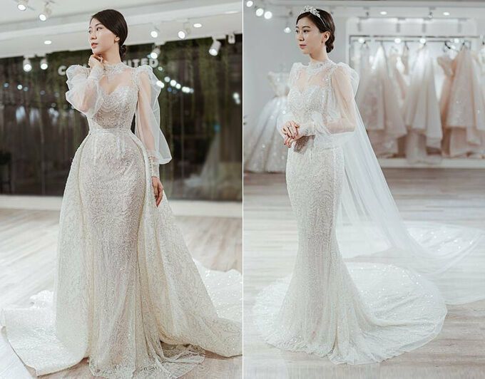 Váy cưới 2 trong 1 của cô dâu Cẩm Tú có dáng đuôi cá cơ bản và tà phụ giúp cô dâu biến hóa linh hoạt giữa các phong cách. Thiết kế đính kết họa tiết 3D lấy cảm hứng từ đường diềm kiến trúc Phục Hưng. Cẩm Tú cho biết cô cùng ekip đã dành 2 năm để bàn bạc về ý tưởng và hoàn thiện tất cả các công đoạn làm nên chiếc váy. Bởi váy cưới không chỉ đơn giản là một bộ lễ phục mà còn thể hiện tính cách, tâm hồn của người chủ sở hữu nên Cẩm Tú đã cảm thấy vô cùng xúc động ngay trong lần thử váy đầu tiên.