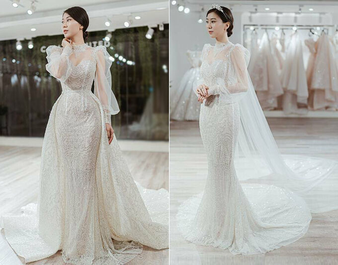 Váy cưới 2 trong 1 của cô dâu Cẩm Tú có dáng đuôi cá cơ bản và tà phụ giúp cô dâu biến hóa linh hoạt giữa các phong cách. Thiết kế đính kết họa tiết 3D lấy cảm hứng từ đường diềm kiến trúc Phục Hưng. Cẩm Tú cho biết cô cùng ekip đã dành 2 năm để bàn bạc về ý tưởng và hoàn thiện tất cả các công đoạn làm nên chiếc váy. Bởi váy cưới không chỉ đơn giản là một bộ lễ phục mà còn thể hiện tính cách, tâm hồn của người chủ sở hữu nên Cẩm Tú đã cảm thấy vô cùng xúc động ngay trong lần thử váy đầu tiên.