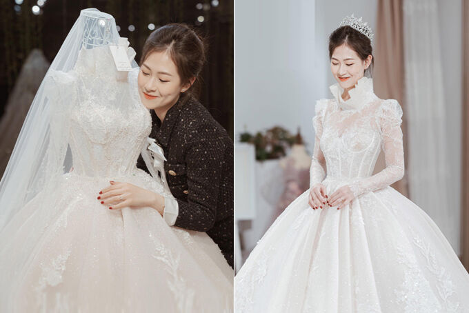 Váy cưới phong cách hoàng gia của cô dâu Khánh Huyền có dáng xòe bồng bềnh, tùng váy xếp ly và đuôi dài được làm bằng chất liệu ren tơ mờ Pháp. Phần cổ áo tạo dáng một bông hoa calla e ấp nở, tôn vóc dáng nhỏ mảnh, cổ cao thon, gương mặt đài các của cô dâu.