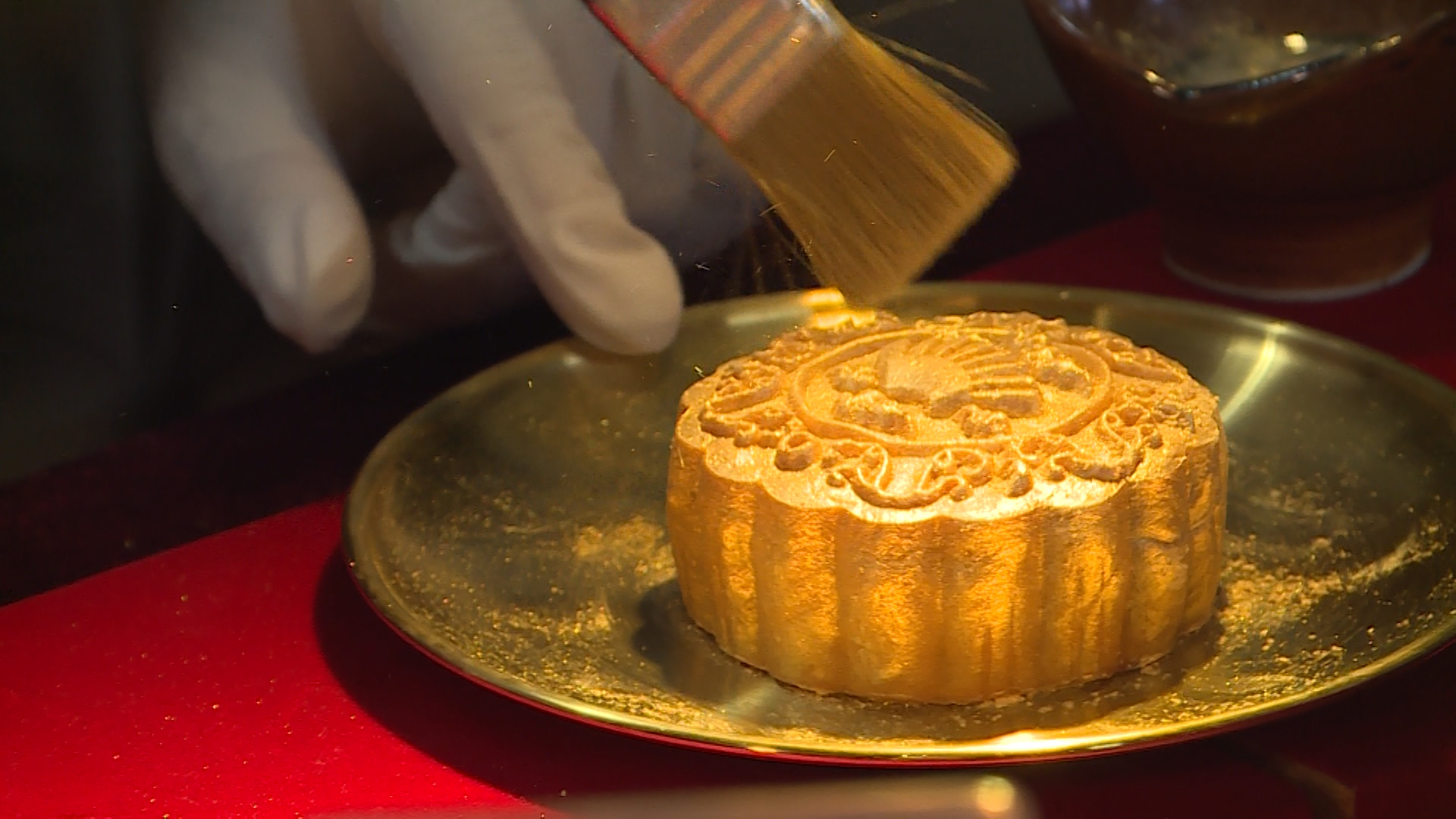 Phủ bột vàng giúp tạo độ sáng và ánh kim cho bánh trung thu (Ảnh: Đông Khánh)