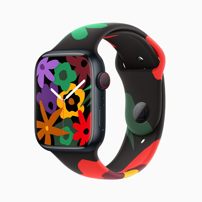 Hình ảnh Apple Watch Series 9 với dây đeo trong Bộ Sưu Tập Black Unity và mặt đồng hồ mới; trong hình ảnh này, mặt đồng hồ có một chùm hoa với màu sắc cầu vồng.